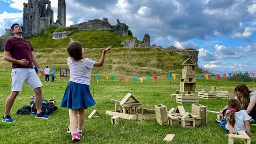 Family playing in Corfe Castle